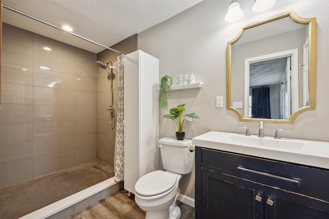 bathroom featuring vanity, toilet, curtained shower, and hardwood / wood-style floors