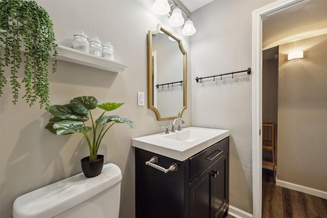 bathroom with vanity, hardwood / wood-style floors, and toilet