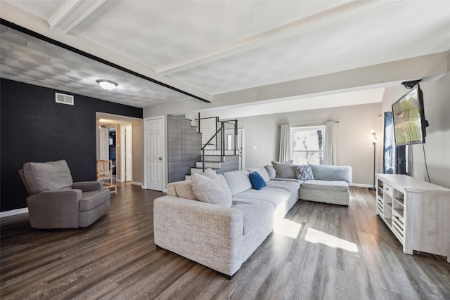 living room with dark hardwood / wood-style flooring and beamed ceiling