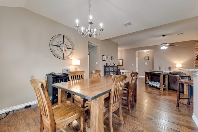 dining room featuring ceiling fan with notable chandelier, lofted ceiling, and hardwood / wood-style floors