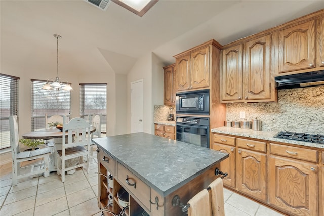 kitchen featuring a kitchen island, lofted ceiling, hanging light fixtures, light tile patterned floors, and black appliances