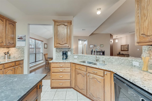 kitchen with black dishwasher, sink, decorative backsplash, kitchen peninsula, and light stone countertops