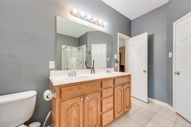 bathroom featuring vanity, toilet, an enclosed shower, and tile patterned flooring