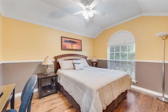 bedroom featuring hardwood / wood-style flooring, crown molding, lofted ceiling, and ceiling fan