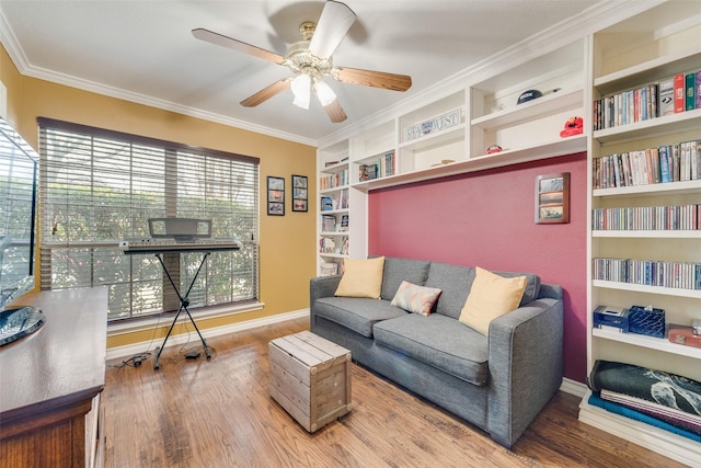 interior space featuring hardwood / wood-style flooring, ornamental molding, ceiling fan, and built in shelves