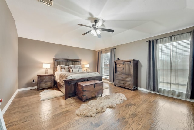 bedroom featuring lofted ceiling, ceiling fan, and light hardwood / wood-style flooring