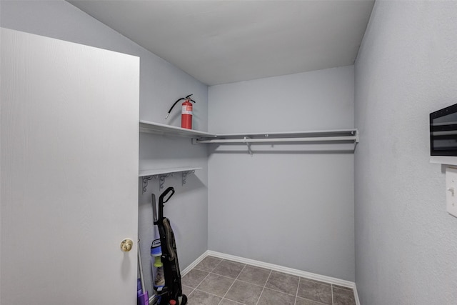 walk in closet with tile patterned floors