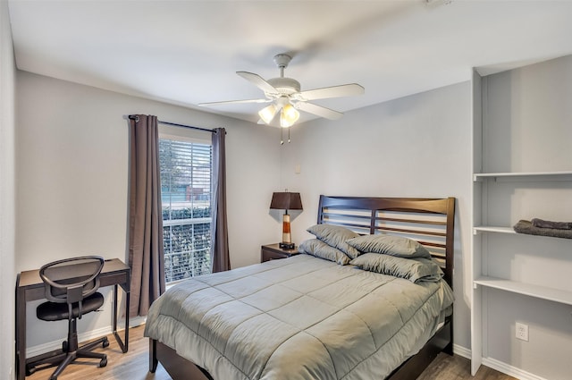 bedroom with hardwood / wood-style floors and ceiling fan