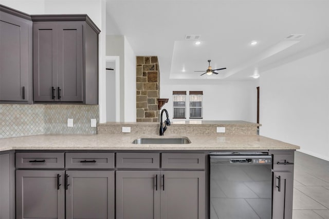 kitchen featuring gray cabinetry, sink, a raised ceiling, and dishwasher