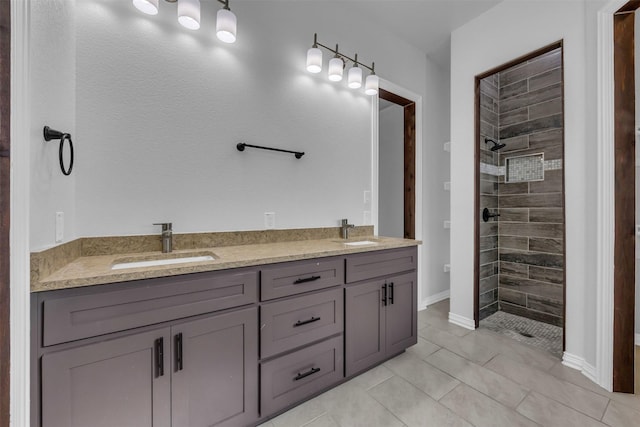 bathroom with vanity and a tile shower