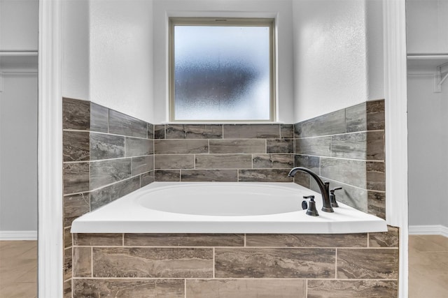 bathroom featuring a relaxing tiled tub and tile patterned floors