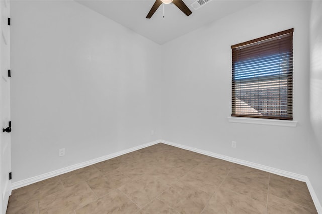 empty room with light tile patterned floors and ceiling fan