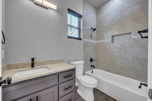 full bathroom with vanity, toilet, and tiled shower / bath