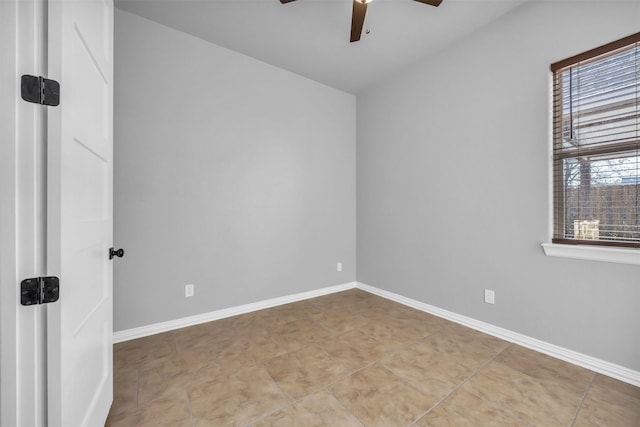 tiled spare room with ceiling fan