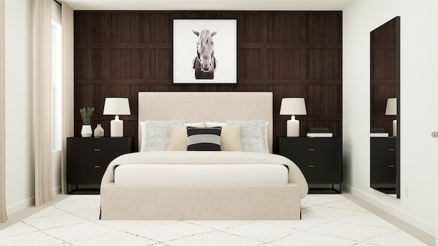 bedroom with light carpet and wood walls