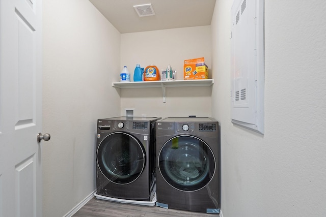 305 Grenada Lake Dr, Princeton, TX 75407 - washroom with wood-type flooring, electric panel, and washer and clothes dryer