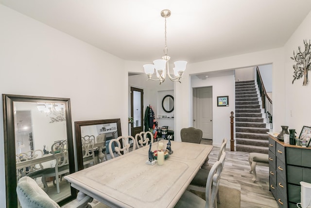 dining space with a chandelier and light hardwood / wood-style flooring