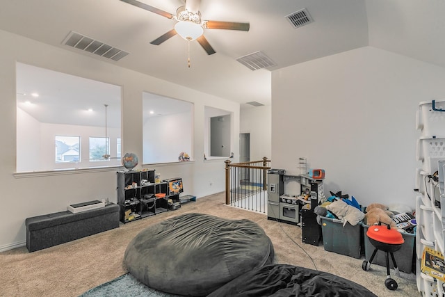 interior space featuring vaulted ceiling, light colored carpet, and ceiling fan