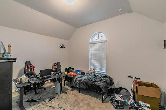 carpeted home office with vaulted ceiling