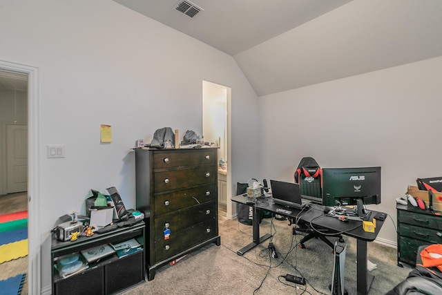 carpeted office space featuring vaulted ceiling