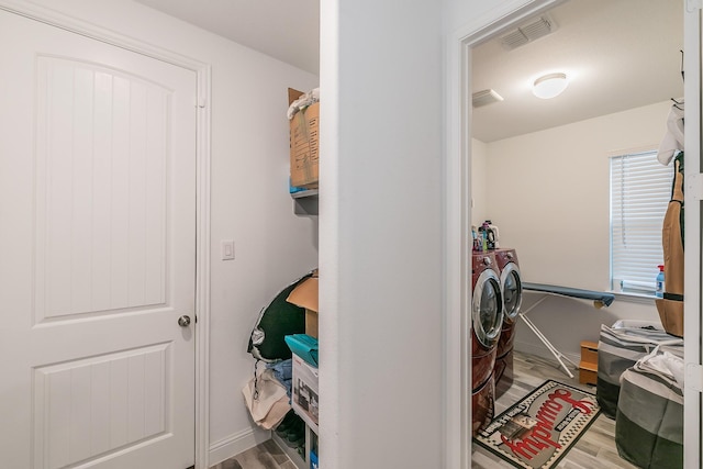 interior space with wood-type flooring and washer and clothes dryer