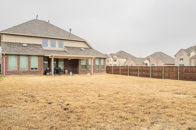 back of property featuring a lawn