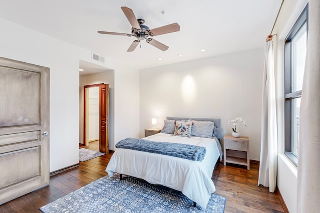 bedroom with dark hardwood / wood-style floors and ceiling fan