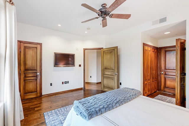 bedroom with dark hardwood / wood-style floors and ceiling fan