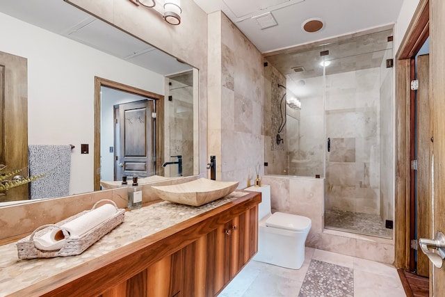 bathroom featuring vanity, tile walls, an enclosed shower, and toilet