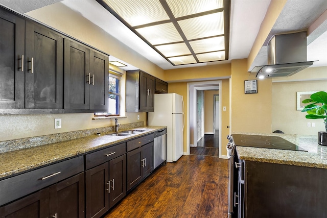 kitchen with extractor fan, appliances with stainless steel finishes, dark hardwood / wood-style floors, sink, and light stone countertops