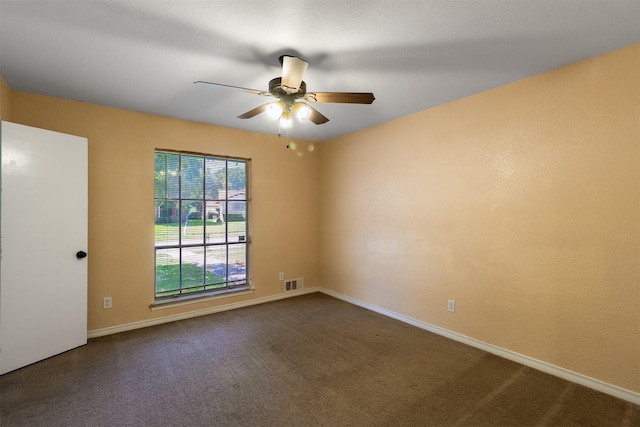 carpeted spare room featuring ceiling fan