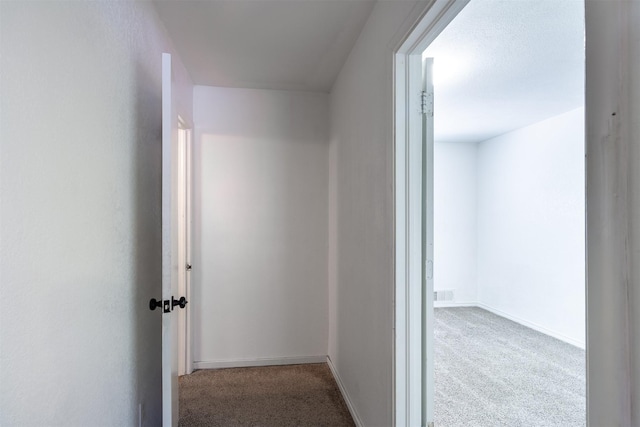 hall featuring light colored carpet