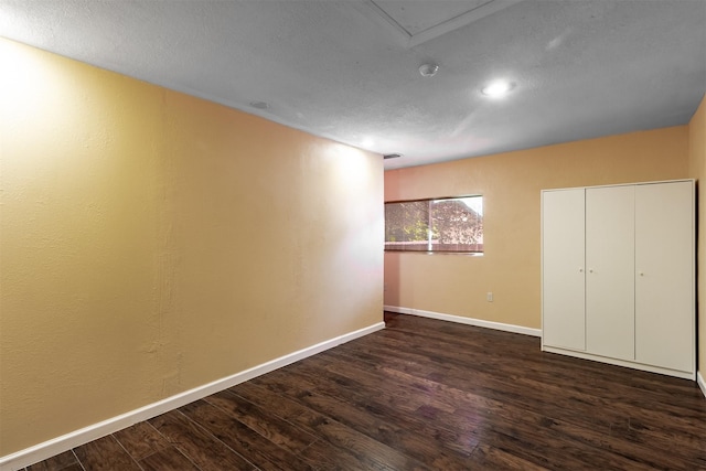 unfurnished bedroom with dark wood-type flooring