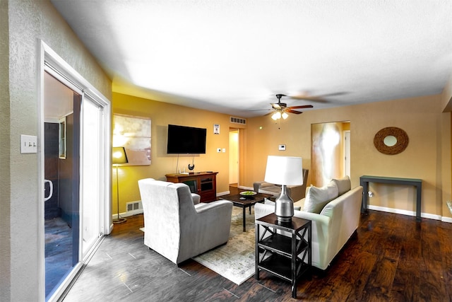 living room with ceiling fan and dark hardwood / wood-style flooring