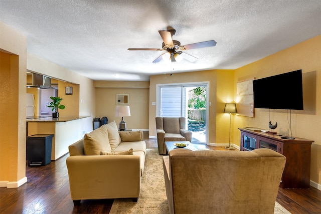 living room featuring dark hardwood / wood-style flooring, a textured ceiling, and ceiling fan