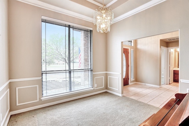 unfurnished room with a raised ceiling, ornamental molding, light colored carpet, and a chandelier