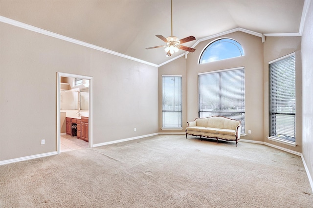 unfurnished room featuring high vaulted ceiling, ornamental molding, light colored carpet, and ceiling fan