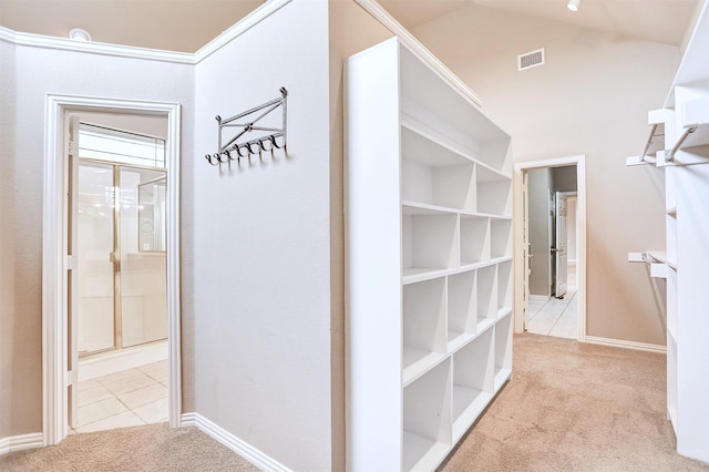 hall with light colored carpet and lofted ceiling