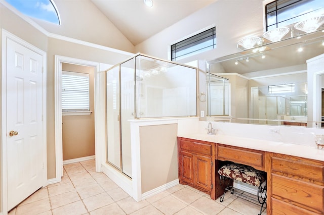 bathroom with tile patterned floors, a shower with shower door, vaulted ceiling, and vanity