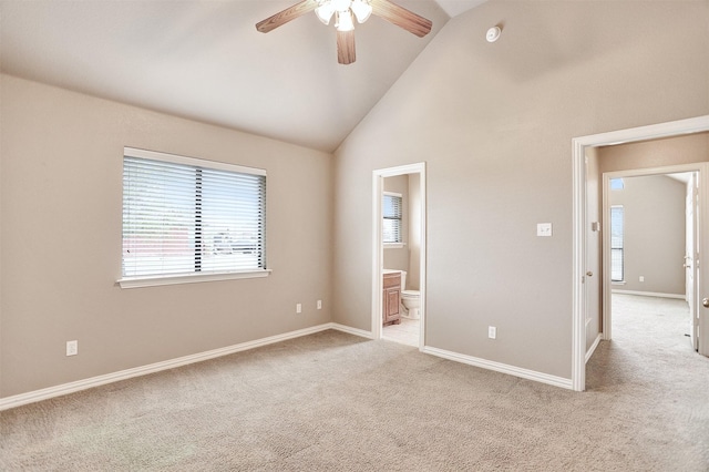 spare room with high vaulted ceiling, light colored carpet, and ceiling fan