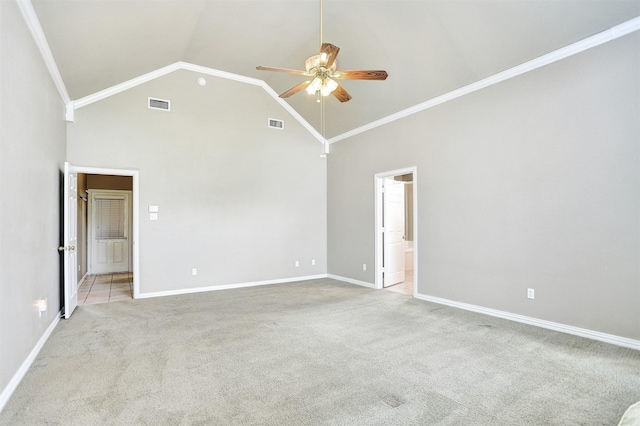 empty room with ornamental molding, high vaulted ceiling, light colored carpet, and ceiling fan