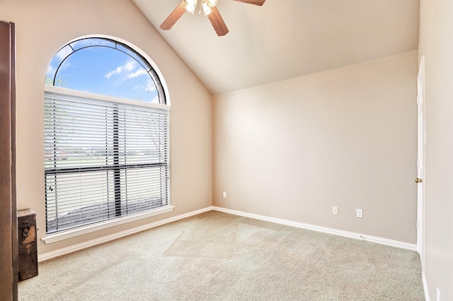 carpeted spare room featuring lofted ceiling and ceiling fan