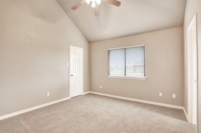 carpeted spare room featuring ceiling fan and high vaulted ceiling