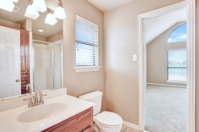 bathroom featuring vanity, plenty of natural light, walk in shower, and toilet