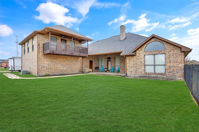 rear view of property with central AC, a patio, a balcony, and a lawn