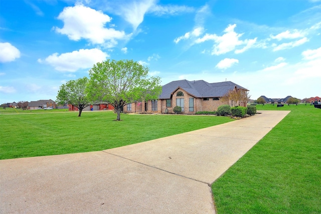 single story home featuring a front lawn