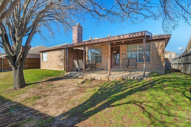 rear view of house featuring a yard and a patio area