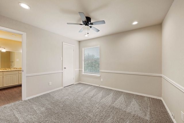 unfurnished bedroom featuring connected bathroom, ceiling fan, and carpet