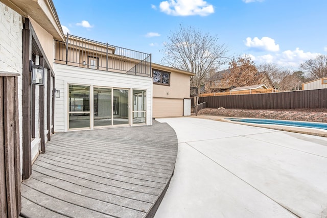 wooden terrace with a fenced in pool