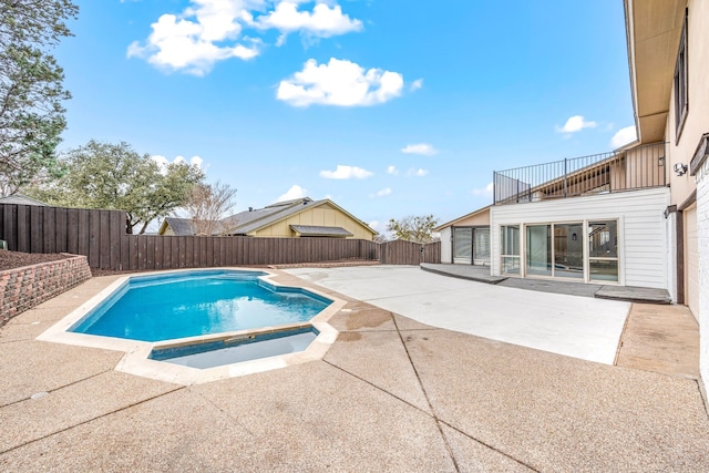 view of pool featuring a patio area and an in ground hot tub